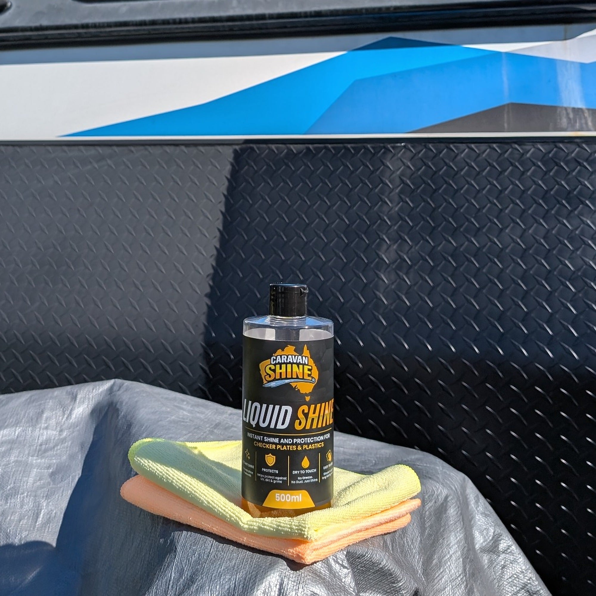 Liquid Shine bottle with microfiber cloths on a caravan checker plate