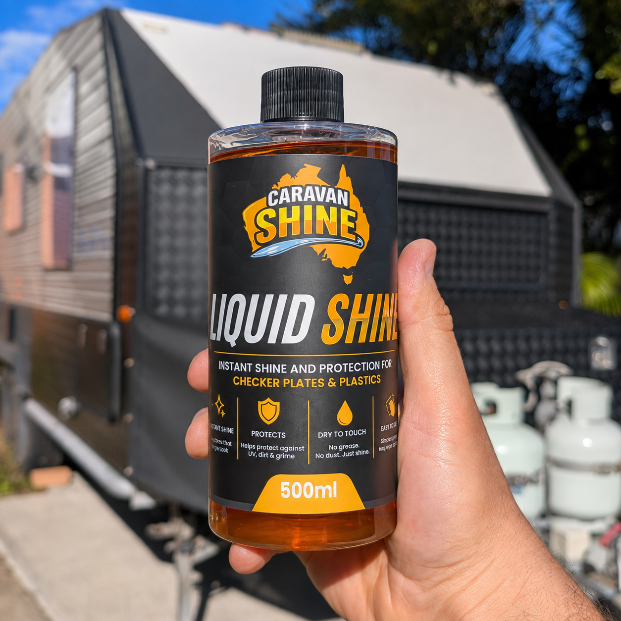 Hand holding Caravan Shine Liquid Shine in front of their caravan